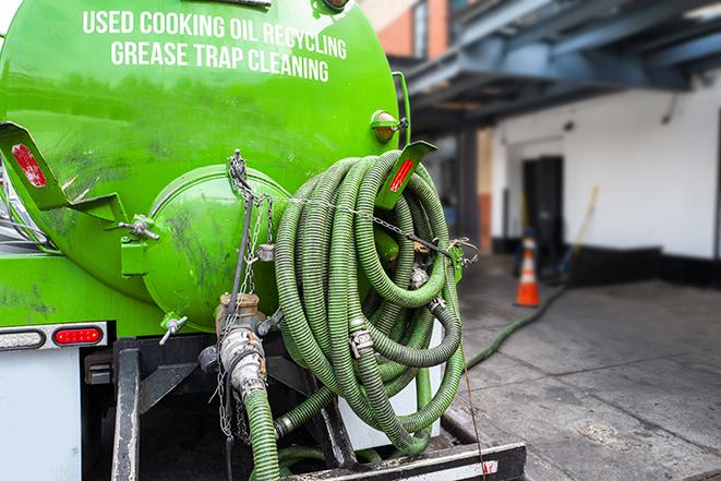 licensed technician pumping a grease trap in Belleair Bluffs, FL